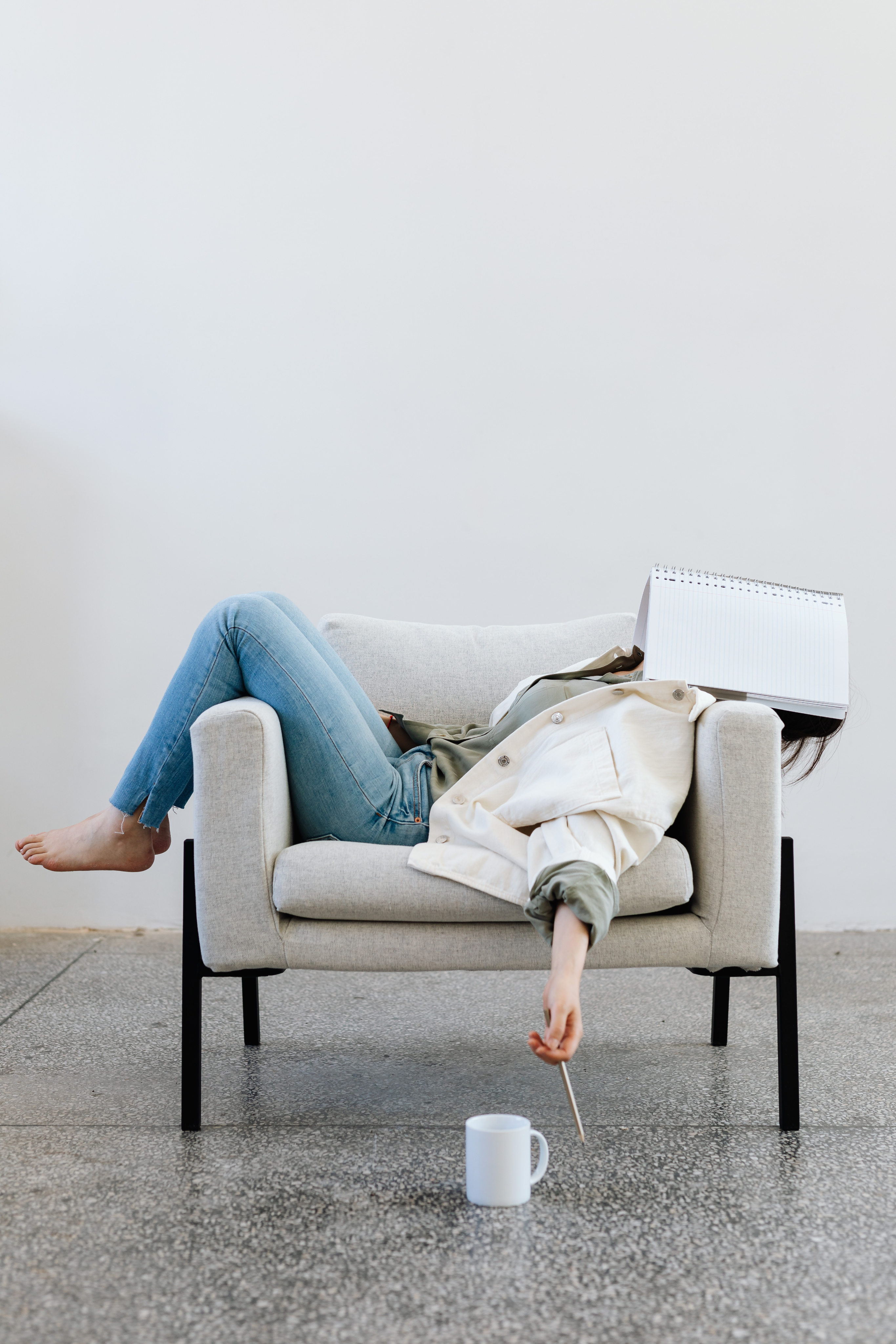 A woman relaxing in an armchair, sketchbook in hand — the creative process, made effortless